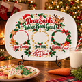 Dear Santa We've Been Good personalized platter on a black metal stand by the fireplace with cookies, milk and a carrot