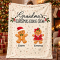 Grandma's Christmas Cookie Crew personalized blanket with 2 grandkids' names, held up in a Christmas living room
