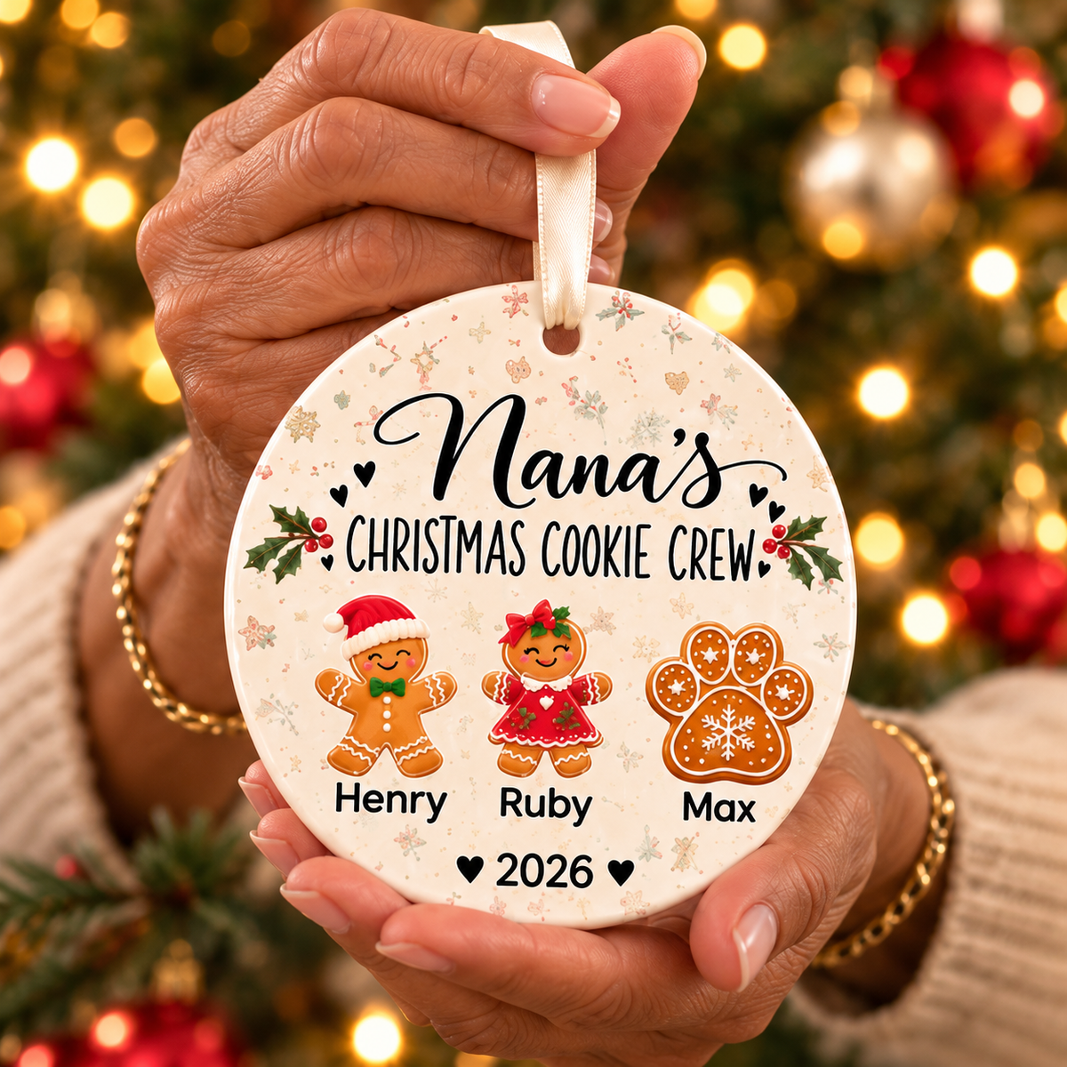 Nana holding her Christmas Cookie Crew ornament with two grandkids and a paw cookie for the family pet