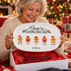 Grandmother unboxing her Gigi's Christmas Cookie Crew platter with display stand in a gift box