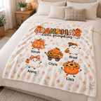 Grandma's Little Pumpkins blanket laid across a bed