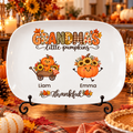 Grandma's Little Pumpkins personalized Thanksgiving platter on a black metal display stand on a fall table