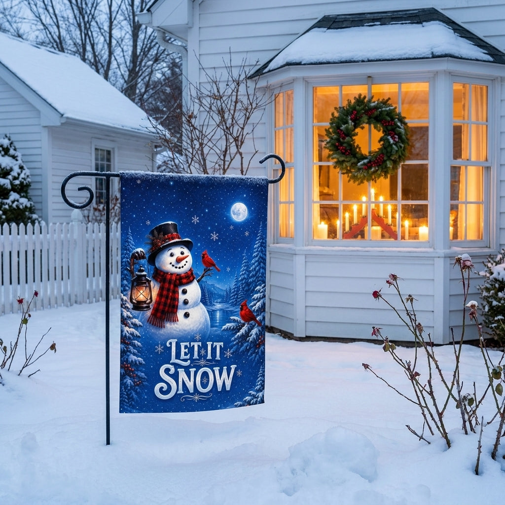 Let It Snow garden flag outside a white cottage with a lit bay window