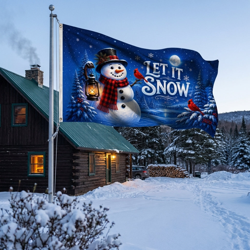 Let It Snow 3x5 ft Christmas flag rippling on a flagpole outside a snowy log cabin